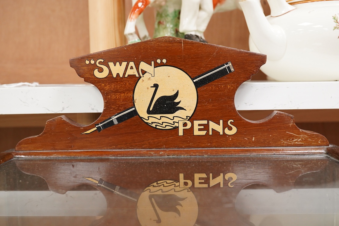 A rare complete Mabie Todd & Co. Swan pen cabinet with original signage and trays to hold twenty four pens, with key for lockable rear door